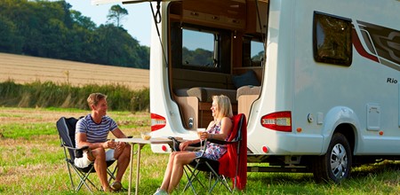 Man and women outside motorhome